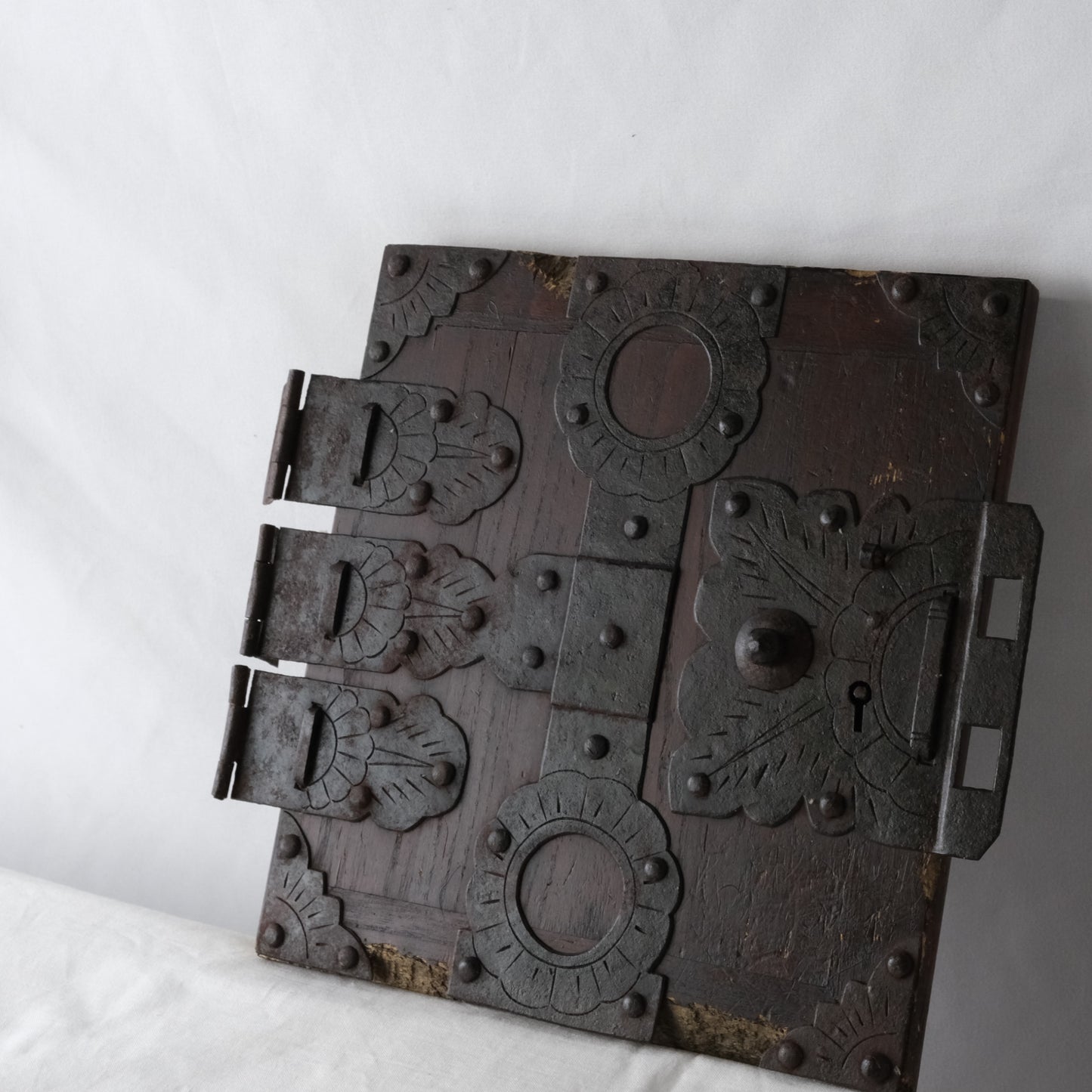 Additional overall view of the detached wooden door and metal fittings.