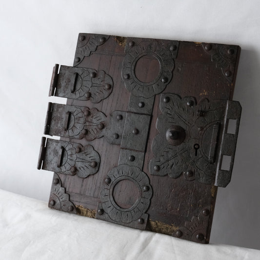 Oblique view of the detached funa tansu door and its projecting metal fittings.