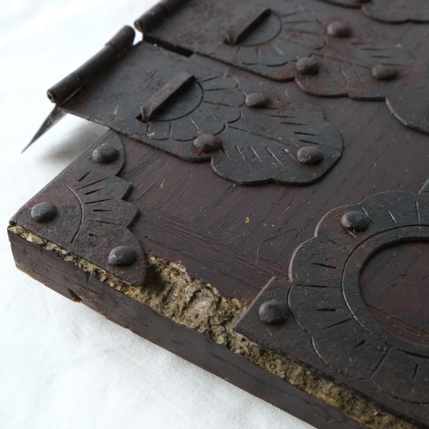 Close-up showing areas of wood loss and worn finish on the door.