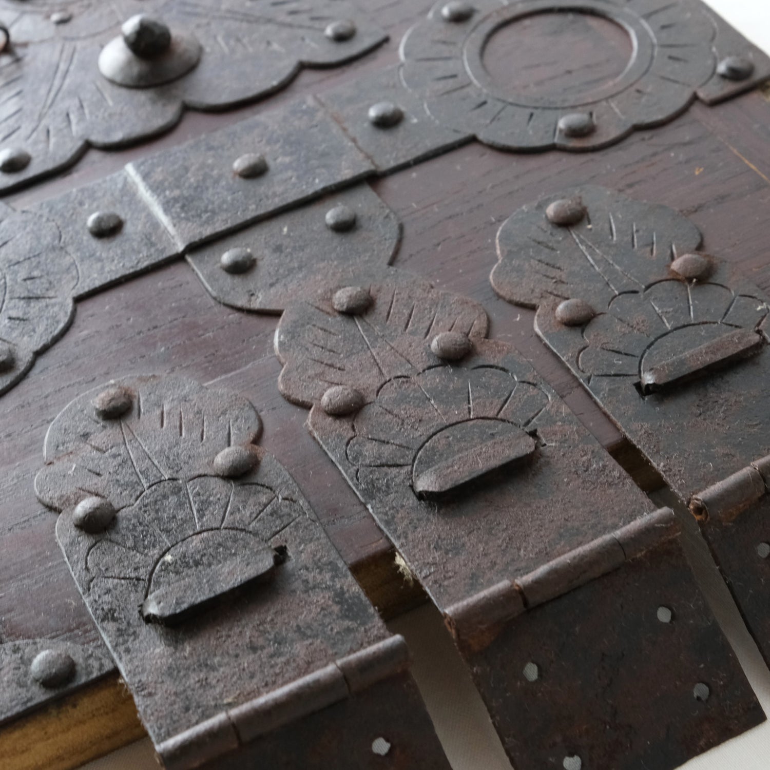 Detail of hinges and decorative metal fittings with rust and wear.