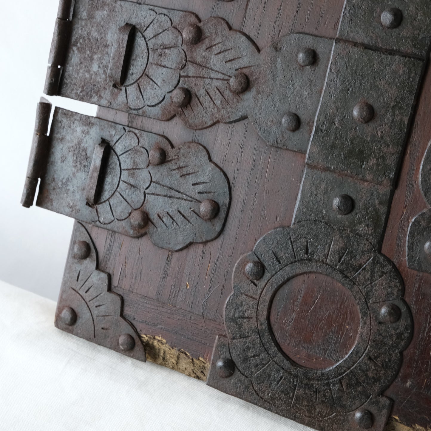Detail of aged metal surfaces and the wooden panel.